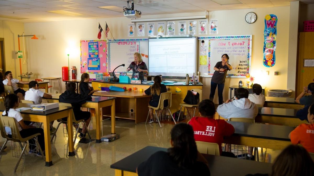 View from back of classroom as Trinity student presents to elementary classroom